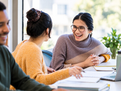 Young adults connecting in a supportive setting, representing therapy for students and young adults.